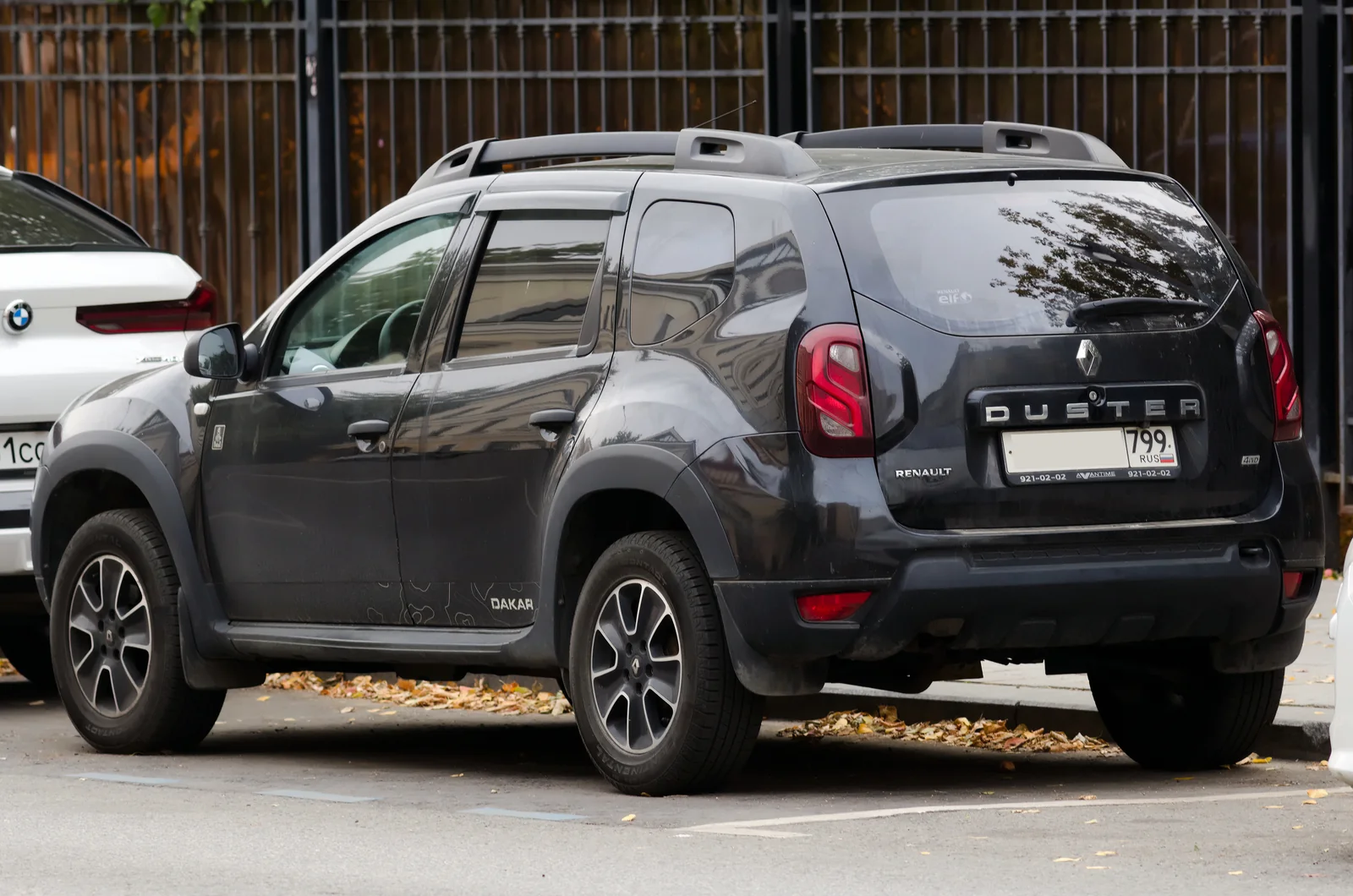Тёмно-серый Renault Duster первого поколения с обозначением Dakar: вид сзади и сбоку
